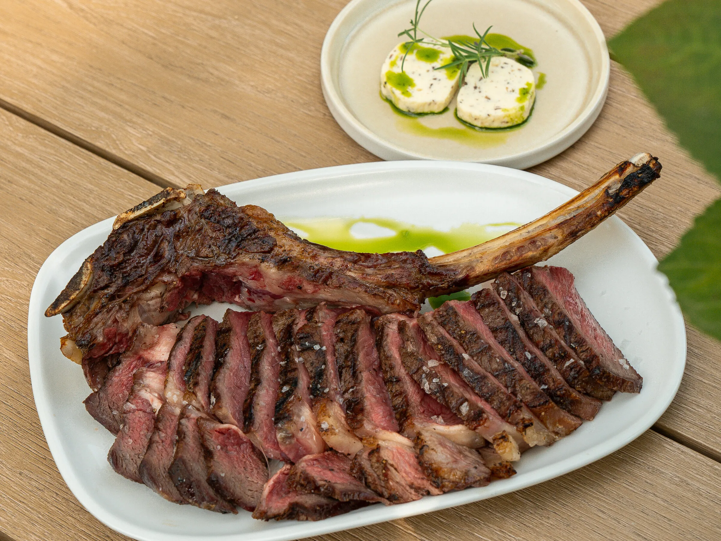 Grilled beef tomahawk, sliced, with herb butter at ÉTÉ